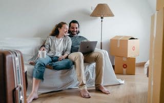 man and woman sitting around boxes