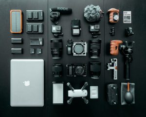 photography equipment flat laid on a black background